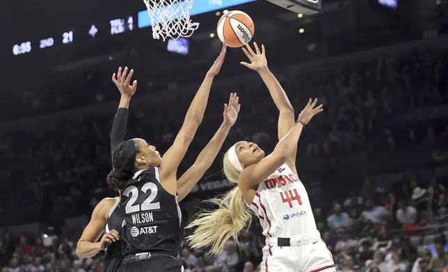 Washington Mystics forward Kiki Iriafen (44) shoots a layup against Las Vegas Aces center A'ja Wilson (22) during the first half of a WNBA basketball game Friday, May 23, 2025, in Las Vegas. (Steve Marcus/Las Vegas Sun via AP)