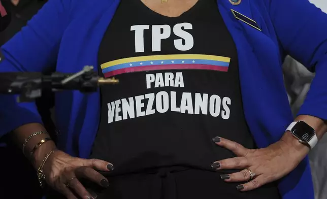 FILE - Activist Helene Villalonga wears a tee-shirt calling for Temporary Protected Status for Venezuelans during a press conference to denounce changes to the protections that shielded hundreds of thousands of Venezuelans from deportation, Feb. 3, 2025, in Doral, Fla. (AP Photo/Rebecca Blackwell, File)