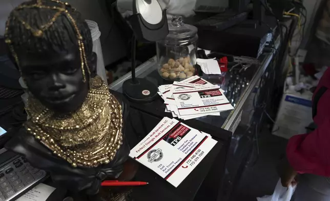 FILE - Cards with information on the Temporary Protected Status, which allows thousands of Haitian immigrants to reside legally in the United States, sit on display at Milokan Botanica, a religious supply shop that sells Haitian spiritual and natural healing products, in Springfield, Ohio, January 25, 2025. (AP Photo/Luis Andres Henao, File)