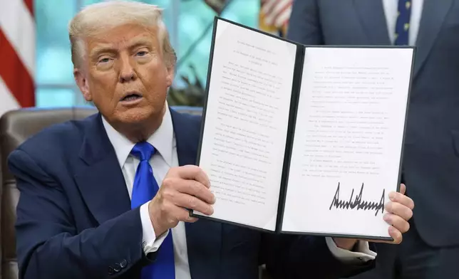 President Donald Trump holds a proclamation on National Hurricane Preparedness week in the Oval Office of the White House, Monday, May 5, 2025, in Washington. (AP Photo/Alex Brandon)