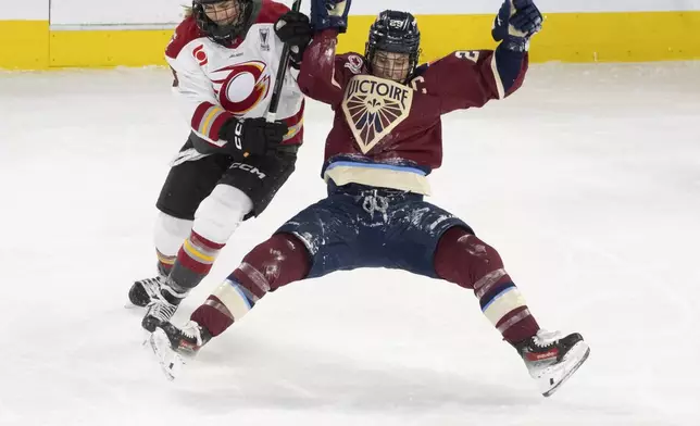 Montreal Victoire's Marie-Philip Poulin (29) and Ottawa Charge's Tereza Vanisova (13) battle for the puck during second period PWHL playoff hockey action in Laval, Que., on Thursday, May 8, 2025. (Christinne Muschi/The Canadian Press via AP)