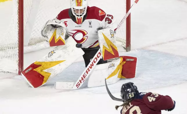 Ottawa Charge goaltender Gwyneth Philips (33) stops a shot by Montreal Victoire's Kristin O'Neill (43) during the third period of a PWHL hockey playoff game in Laval, Quebec, Thursday, May 8, 2025. (Christinne Muschi/The Canadian Press via AP)