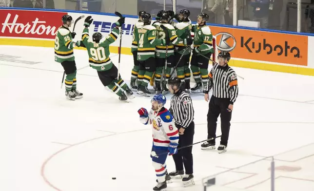 Moncton Wildcats' Markus Vidicek (6) skates off the ice as London Knights players, top, celebrate after their win in semifinal Memorial Cup hockey action in Rimouski, Quebec, Friday, May 30, 2025. (Christopher Katsarov/The Canadian Press via AP)