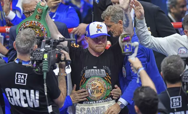 Canelo Alvarez, center, celebrates after wining against William Scull during super middleweight World Boxing Championship at ANB Arena in Riyadh, Saudi Arabia, Sunday, May 4, 2025. (AP Photo)