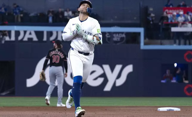Toronto Blue Jays shortstop Bo Bichette (11) gestures as he runs the bases after hitting a solo home run against the Cleveland Guardians during the first inning of a baseball game in Toronto, Saturday, May 3, 2025. (Jon Blacker/The Canadian Press via AP)