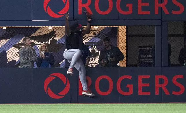 Cleveland Guardians right fielder Jhonkensy Noel (43) misplays a ball off the wall hit by Toronto Blue Jays right fielder George Springer for a double during the first inning of a baseball game in Toronto, Saturday, May 3, 2025. (Jon Blacker/The Canadian Press via AP)