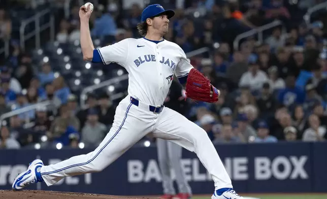 Toronto Blue Jays starting pitcher Kevin Gausman (34) throws to a Cleveland Guardians batter during the first inning of a baseball game in Toronto, Saturday, May 3, 2025. (Jon Blacker/The Canadian Press via AP)