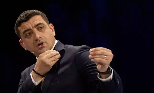 FILE - Presidential candidate George Simion gestures during a live electoral debate with presidential candidate Nicusor Dan ahead of the second round of the country's presidential election redo in Bucharest, Romania, Thursday, May 8, 2025. (AP Photo/Andreea Alexandru, File)