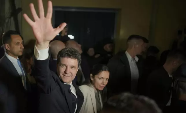 Presidential candidate Nicusor Dan waves to his supporters after polls closed for the second round of the country's presidential election redo in Bucharest, Romania, early Monday, May 19, 2025. (AP Photo/Vadim Ghirda)