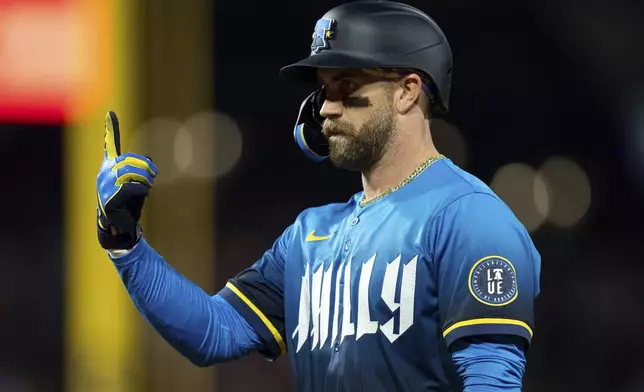 Philadelphia Phillies' Bryce Harper reacts after his RBI single during the fifth inning of a baseball game against the Pittsburgh Pirates, Friday, May 16, 2025, in Philadelphia. (AP Photo/Chris Szagola)