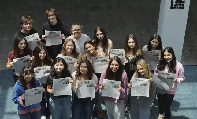 Members of Tideline, the student newspaper, pose for a group photo showing the publication at the interim location for Palisades High School Wednesday, May 14, 2025, in Santa Monica, Calif. (AP Photo/Marcio Jose Sanchez)