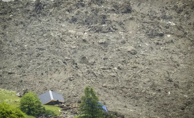 A large avalanche with a mixture of ice, rock, snow and water reach the valley floor is pictured in Wiler after the Birch glacier collapsing above Blatten, Switzerland, Wednesday, May 28, 2025. (Jean-Christophe Bott/Keystone via AP)
