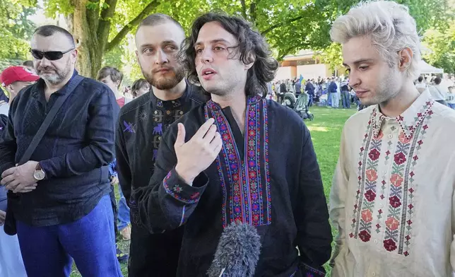 Eurovision competitor band Ziferblat from Ukraine gives an interview to the Associated Press during a family meeting of Ukrainian people in a park in Basel as part of the 69th Eurovision Song Contest week, in Basel, Switzerland, Thursday, May 15, 2025. (AP Photo/Martin Meissner)