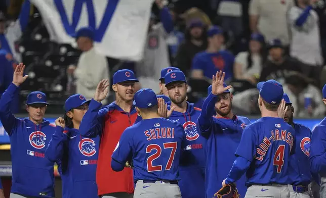 Chicago Cubs' Seiya Suzuki (27), of Japan, celebrates with teammates after a baseball game against the New York Mets Saturday, May 10, 2025, in New York. (AP Photo/Frank Franklin II)
