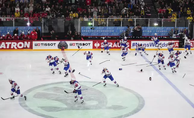 Team USA celebrates after winning the final match between United States and Switzerland at the ice hockey world championships in Stockholm, Sweden, Sunday, May 25, 2025. (AP Photo/Petr David Josek)