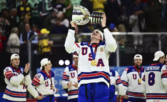 USA's Tage Thompson, who scored the only goal during overtime, holds the trophy after the Hockey World Championship gold medal match between Switzerland and USA at Avicii Arena in Stockholm, Sweden, Sunday May 25, 2025. (Magnus Lejhall/Keystone via AP)