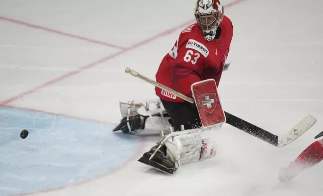 Switzerland's Leonardo Genoni watches the puck go into the net during sudden death overtime during the final match between United States and Switzerland at the ice hockey world championships in Stockholm, Sweden, Sunday, May 25, 2025. (AP Photo/Petr David Josek)