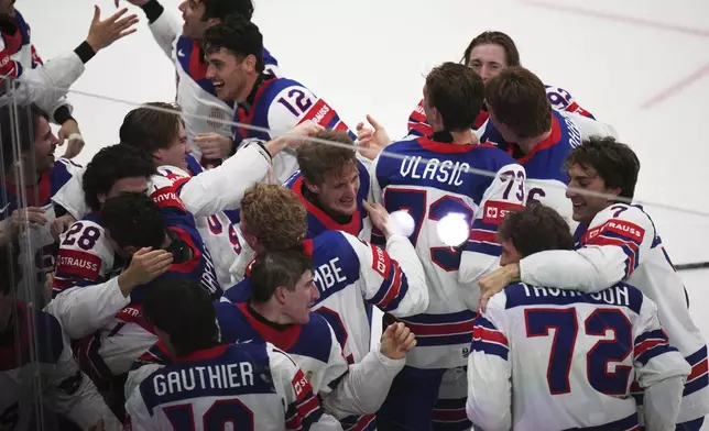 Team USA celebrates after winning the final match between United States and Switzerland at the ice hockey world championships in Stockholm, Sweden, Sunday, May 25, 2025. (AP Photo/Petr David Josek)