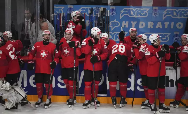 Swiss players stand dejected after the final match between United States and Switzerland at the ice hockey world championships in Stockholm, Sweden, Sunday, May 25, 2025. (AP Photo/Petr David Josek)