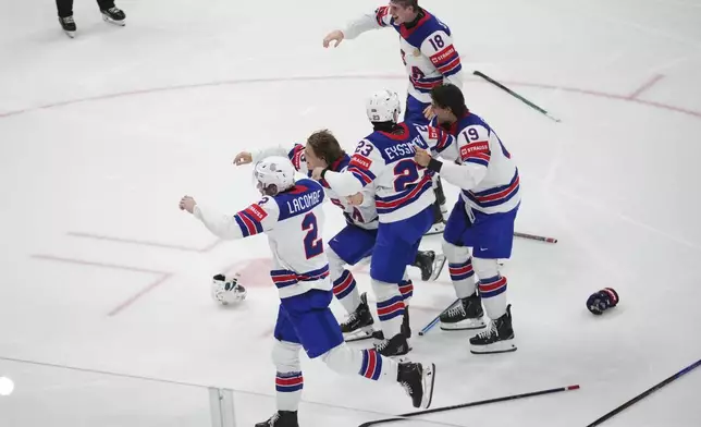 Team USA celebrates after winning the final match between United States and Switzerland at the ice hockey world championships in Stockholm, Sweden, Sunday, May 25, 2025. (AP Photo/Petr David Josek)