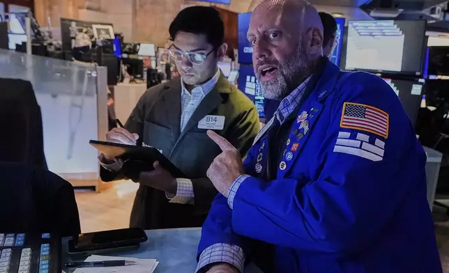 Trader Niall Pawa, left, and specialist Meric Greenbaum work on the floor of the New York Stock Exchange, Monday, May 12, 2025. (AP Photo/Richard Drew)