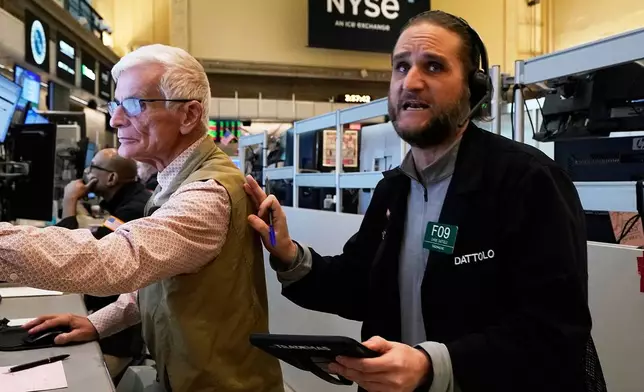 Options trader Chris Dattollo, right, works on the floor of the New York Stock Exchange, Monday, May 12, 2025. (AP Photo/Richard Drew)