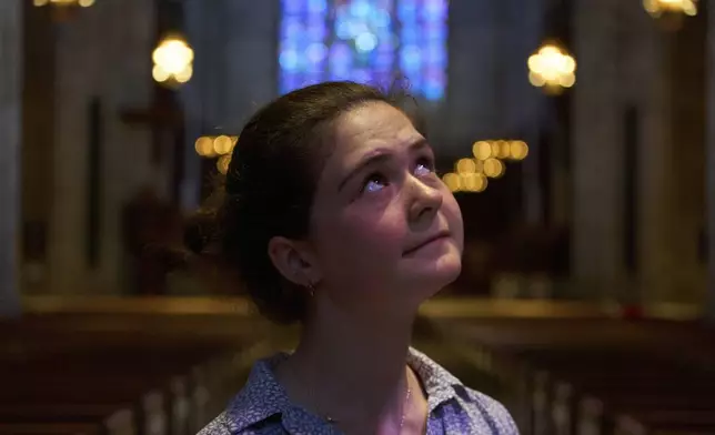 Nadia Makuc, a Catholic and Princeton University student, poses for a portrait at the university chapel after attending a service in Princeton, N.J., on Thursday, May 1, 2025. (AP Photo/Luis Andres Henao)