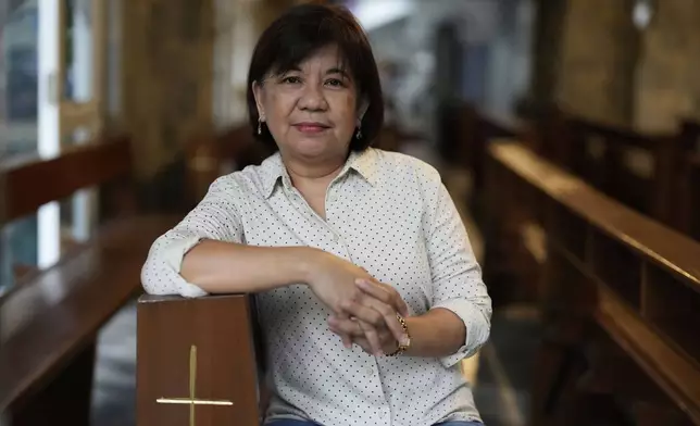 Marileen Onal stands in Our Lady of Perpetual Help Parish in Quezon City, Philippines on Saturday, May 3, 2025. (AP Photo/Aaron Favila)