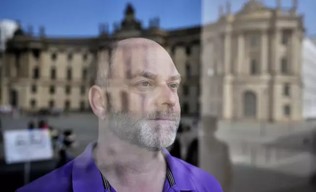 Christoph Rudinger 49, an Austrian Catholic teacher, stands for a portrait at St. Hedwig's Cathedral in Berlin, Germany, Friday, May 2, 2025. (AP Photo/Ebrahim Noroozi)
