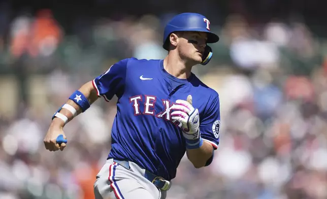 Texas Rangers' Josh Jung rounds first base after hitting a two-run home run against the Detroit Tigers in the fifth inning during a baseball game, Sunday, May 11, 2025, in Detroit. (AP Photo/Paul Sancya)