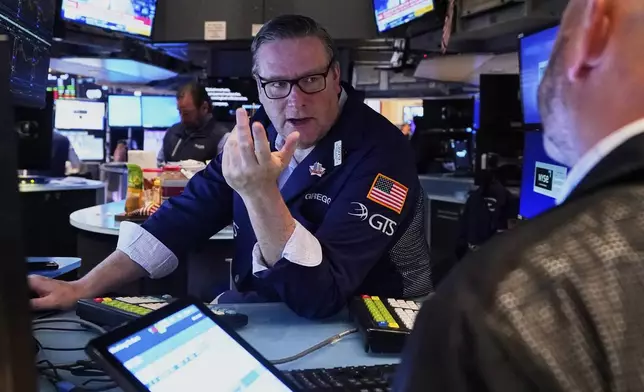 Specialist Gregg Maloney, left, works on the floor of the New York Stock Exchange, Wednesday, May 7, 2025. (AP Photo/Richard Drew)