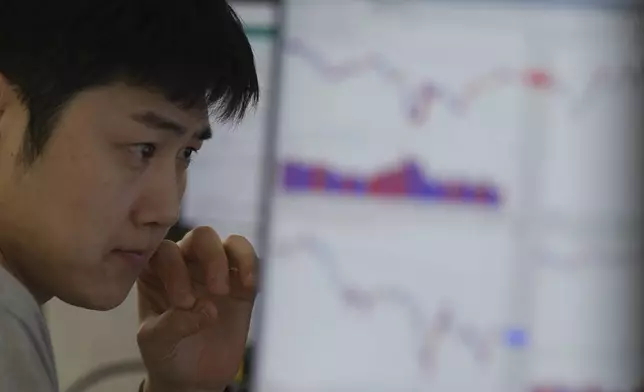 A dealer watches computer monitors at a dealing room of Hana Bank in Seoul, South Korea, Wednesday, May 7, 2025. (AP Photo/Lee Jin-man)