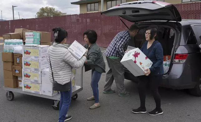 Church members pack groceries in van at the Alameda County Community Food Bank in Alameda, Calif., on Friday, April 25, 2025. (AP Photo/Terry Chea)