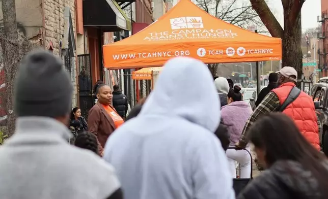 People line up for groceries outside The Campaign Against Hunger's distribution center in the Brooklyn borough of New York, Tuesday, April 15, 2025. (AP Photo/James Pollard)