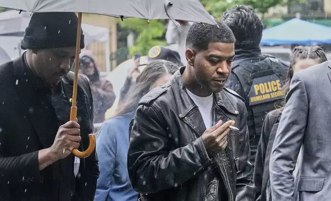 Rapper Kid Cudi, right, arrives at Federal Court for the trial of Sean "Diddy" Combs, in New York, Thursday, May 22, 2025. (AP Photo/Richard Drew)