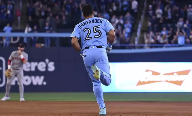Toronto Blue Jays' Anthony Santander (25) runs the bases after hitting a three-run home run against the Boston Red Sox in seventh inning American League baseball action in Toronto on Wednesday, April 30, 2025. (Jon Blacker/The Canadian Press via AP)