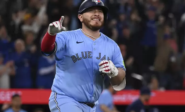 Toronto Blue Jays' Alejandro Kirk (30) runs to first base after hitting a walk-off RBI single in tenth inning American League baseball action to defeat the Boston Red Sox in Toronto on Wednesday, April 30, 2025. (Jon Blacker/The Canadian Press via AP)