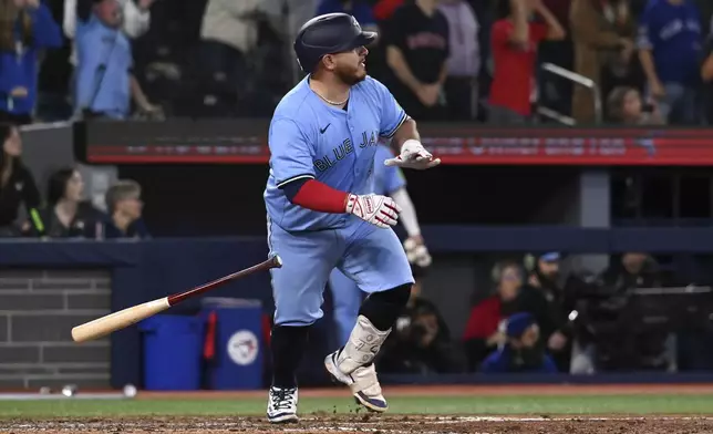 Toronto Blue Jays' Alejandro Kirk (30) hits a walk-off RBI single in tenth inning American League baseball action to defeat the Boston Red Sox in Toronto on Wednesday, April 30, 2025. (Jon Blacker/The Canadian Press via AP)