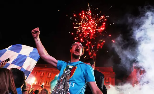 Napoli fans celebrate after winning the Italian league soccer title, in Naples, Italy, Friday, May 23, 2025. (AP Photo/Salvatore Laporta)