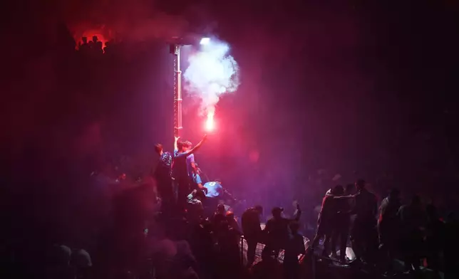 Napoli fans celebrate after winning the Italian league soccer title, in central Naples, Italy, Friday, May 23, 2025. (AP Photo/Salvatore Laporta)