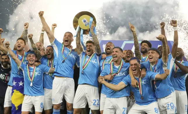 Napoli's players hold the trophy after winning the Italian league soccer title at the end of the Serie A soccer match between Napoli and Cagliari at the Diego Maradona stadium in Naples, Italy, early Saturday, May 24, 2025. (AP Photo/Gregorio Borgia)