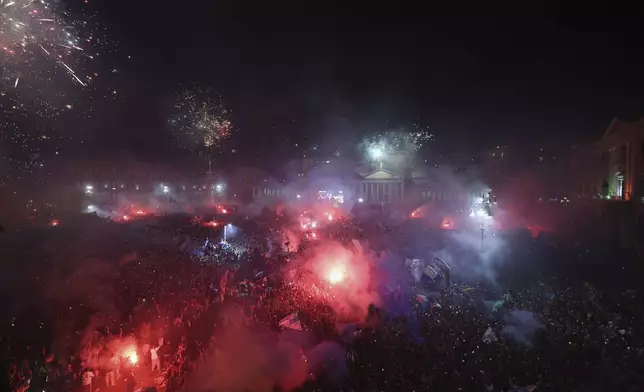 Napoli's fans celebrate with fireworks in Piazza Plebiscito after winning the Italian league soccer title, in central Naples, Italy, Friday, May 23, 2025. (AP Photo/Salvatore Laporta)