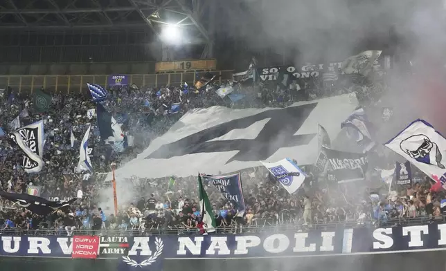 Fans celebrate showing a number 4 during the Italian Serie A soccer match between Napoli and Cagliari at the Diego Maradona stadium in Naples, Italy, Friday, May 23, 2025. (AP Photo/Gregorio Borgia)
