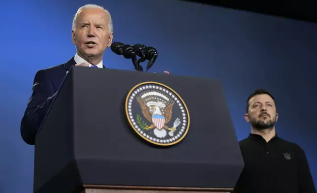 FILE - President Joe Biden, left, joined by President of Ukraine Volodymyr Zelenskyy, speaks during an event on the Ukraine Compact on the sidelines of the NATO Summit in Washington, Thursday, July 11, 2024. (AP Photo/Susan Walsh, File)