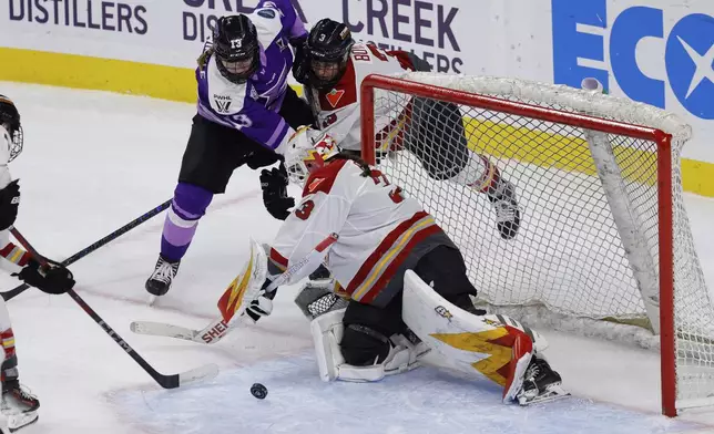 Ottawa Charge goaltender Gwyneth Philips (33) makes a save on a shot from Minnesota Frost forward Grace Zumwinkle (13) during the third period of game 3 of the PWHL final Saturday, May 24, 2025, in St. Paul, Minn. (AP Photo/Bailey Hillesheim)