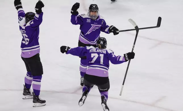 Minnesota Frost forward Katy Knoll (6) celebrates with forward Klára Hymlárová (71) and defenseman Sophie Jaques (16) after scoring during the third overtime period of game 3 of the PWHL final against the Ottawa Charge, Saturday, May 24, 2025, in St. Paul, Minn. (AP Photo/Bailey Hillesheim)