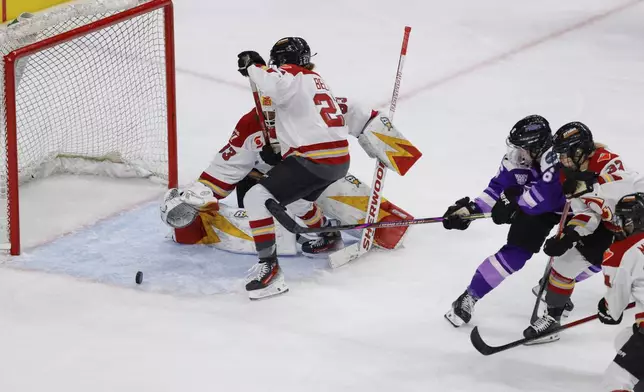 Minnesota Frost forward Katy Knoll (6) scores a goal on Ottawa Charge goaltender Gwyneth Philips (33) during the third overtime period of game 3 of the PWHL final Saturday, May 24, 2025, in St. Paul, Minn. (AP Photo/Bailey Hillesheim)