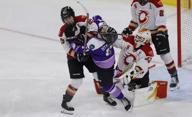 Ottawa Charge defenseman Jocelyne Larocque (23) shoves Minnesota Frost forward Klára Hymlárová (71) during the third period of game 3 of the PWHL final, Saturday, May 24, 2025, in St. Paul, Minn. (AP Photo/Bailey Hillesheim)