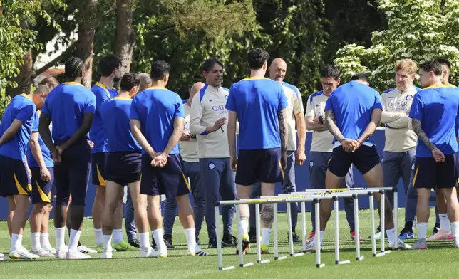 Inter Milan players gather with their head coach Simone Inzaghi during a training session of the Champions League Media Day in view of the Saturday's Champions League final against PSG, at the Inter Milan training center, in Appiano Gentile, Italy, Monday, May 26, 2025. (AP Photo/Antonio Calanni)