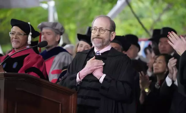 Harvard President Alan Garber acknowledges an extended round of applause during Harvard University's commencement ceremonies, Thursday, May 29, 2025 in Cambridge, Mass. (AP Photo/Charles Krupa)